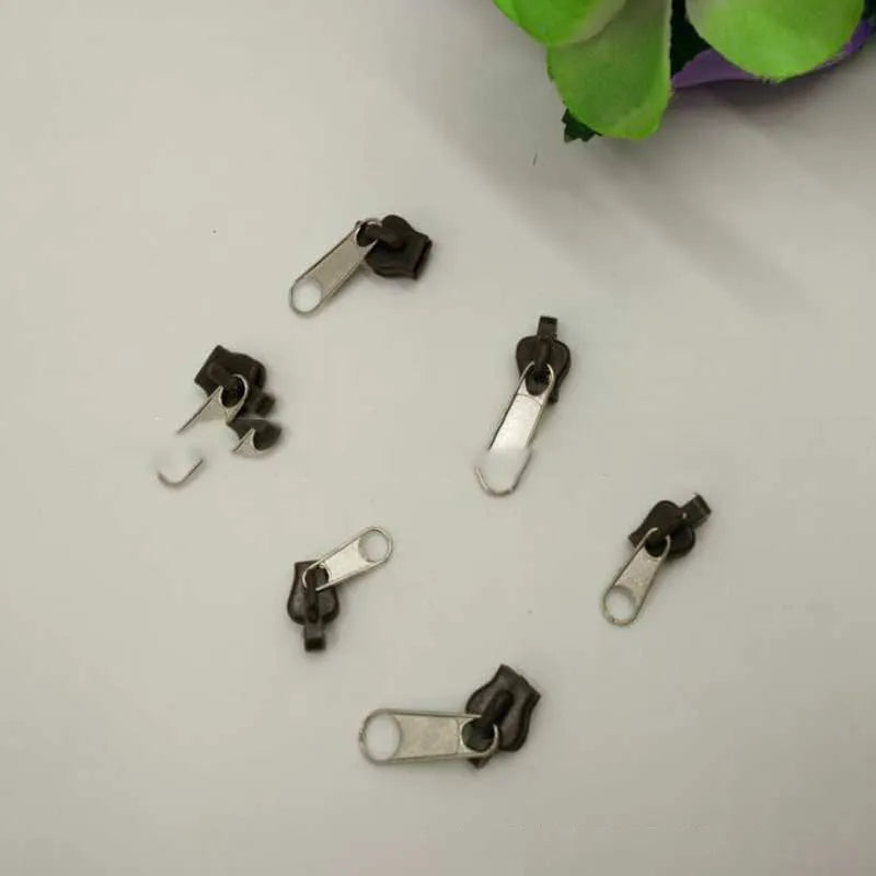 Zipper head replacement kit with 12 plastic and metal snap-on zipper pulls in black, black grey, and coffee brown colours for easy installation, removable and reusable fix for any broken zipper