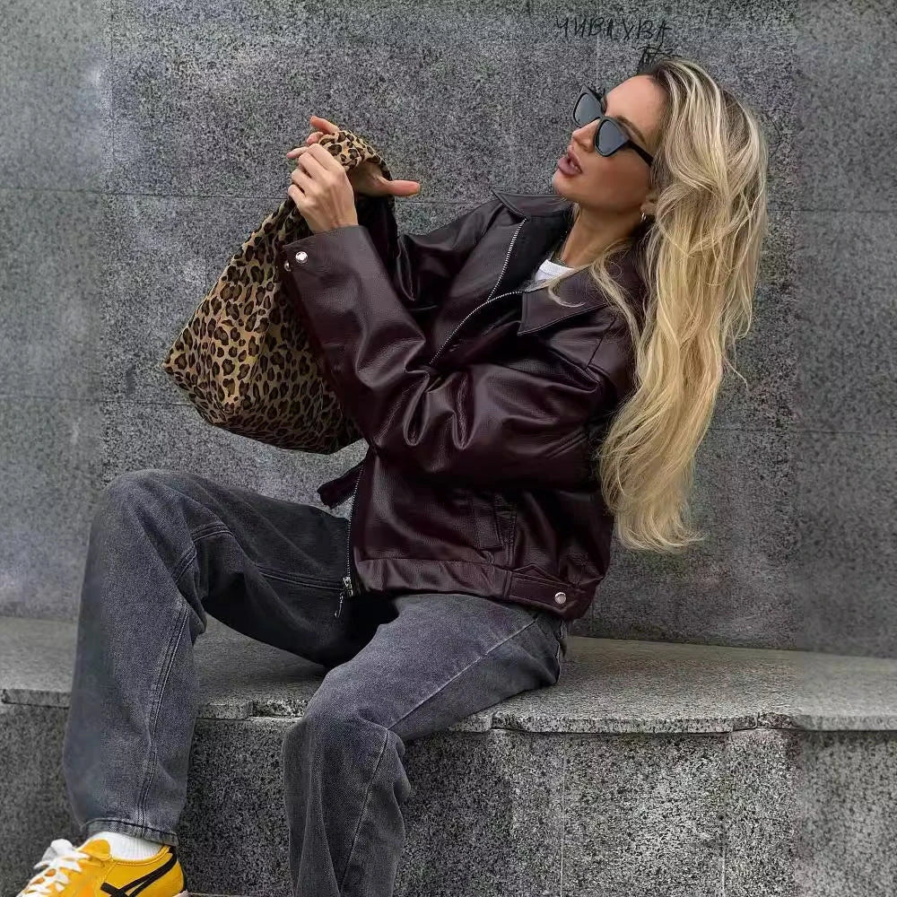A stylish faux leather jacket with a zipper closure and lapel, available in burgundy and black colors.