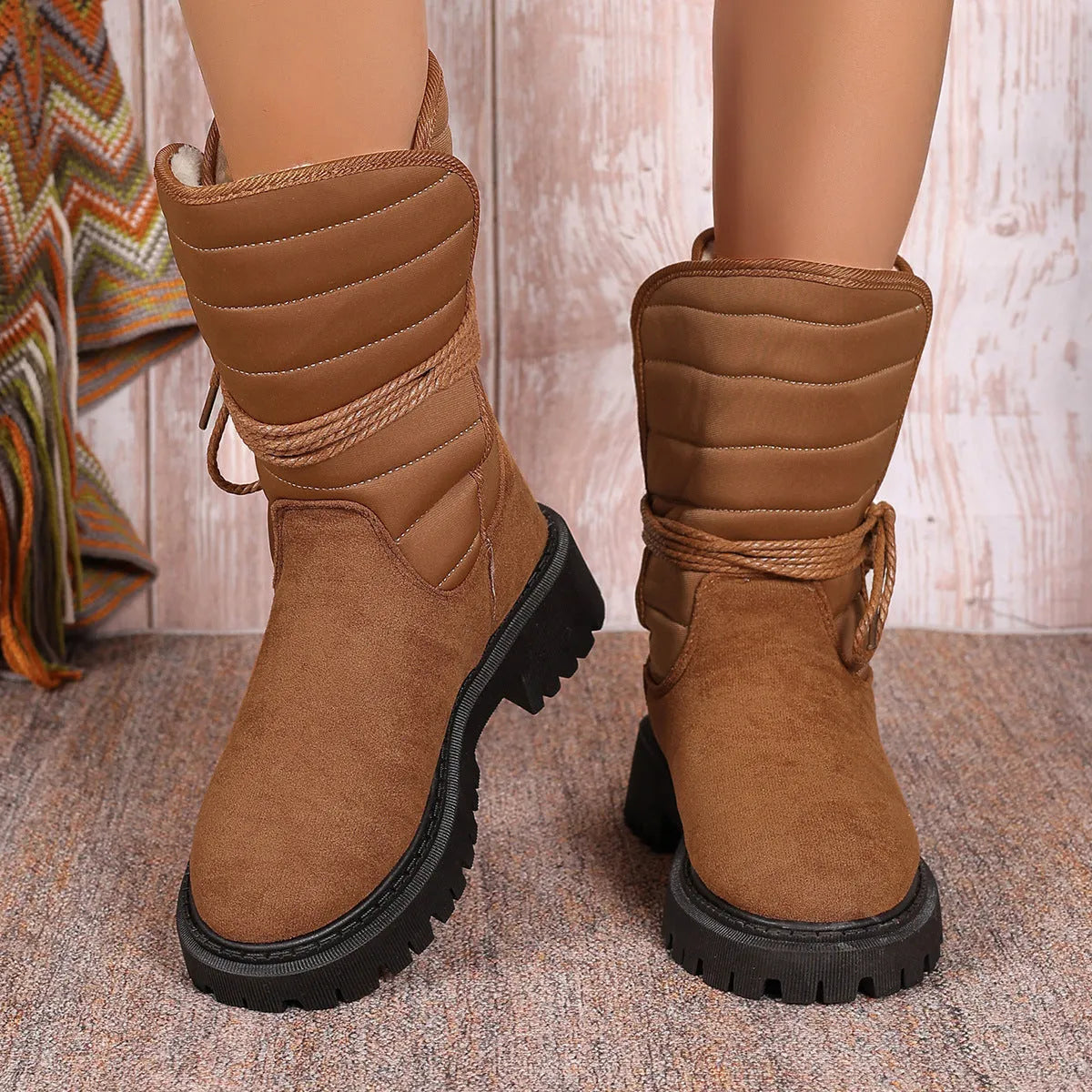 Women's black suede snow boots with chunky heel, fleece lining, and lace-up design for winter wear