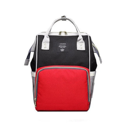 Stylish maternity diaper bag in various colors, featuring a paper bag design, separate bottle compartment, and discreet breastfeeding button.