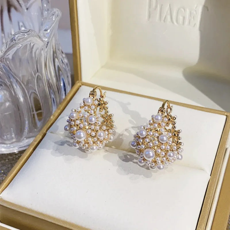 Women's earrings crafted from copper with small rice-shaped bead floral basket design featuring gold colour pearl inlay decoration for all-match minor accessory style, light luxury look