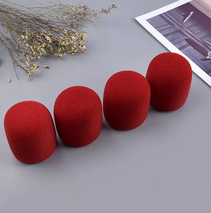 Four foam microphone wind shields in different colours for handheld stage microphones