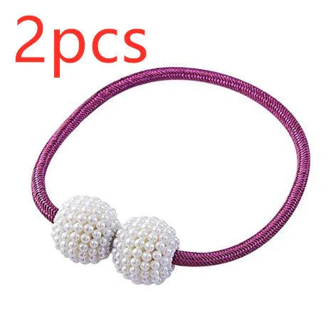 Magnetic curtain tiebacks with white pearl beads and fabric loops holding gathered curtain