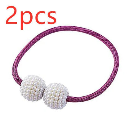 Magnetic curtain tiebacks with white pearl beads and fabric loops holding gathered curtain