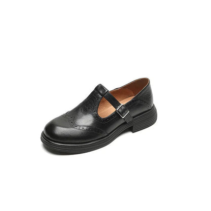 Women's black and brown round-toe flat casual shoes made from sheepskin leather.