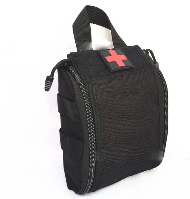 Tactical medical first aid kit open showing gauze, bandages, thermometer, and medicines for outdoor camping.