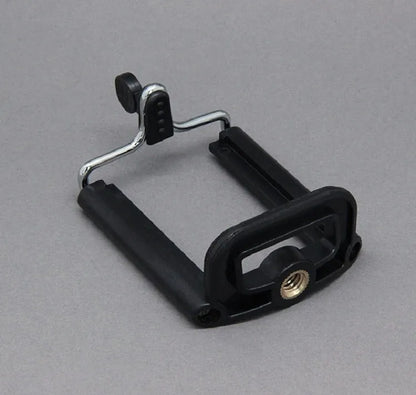Black octopus tripod with flexible rubber legs wrapped around a pole, holding a smartphone.