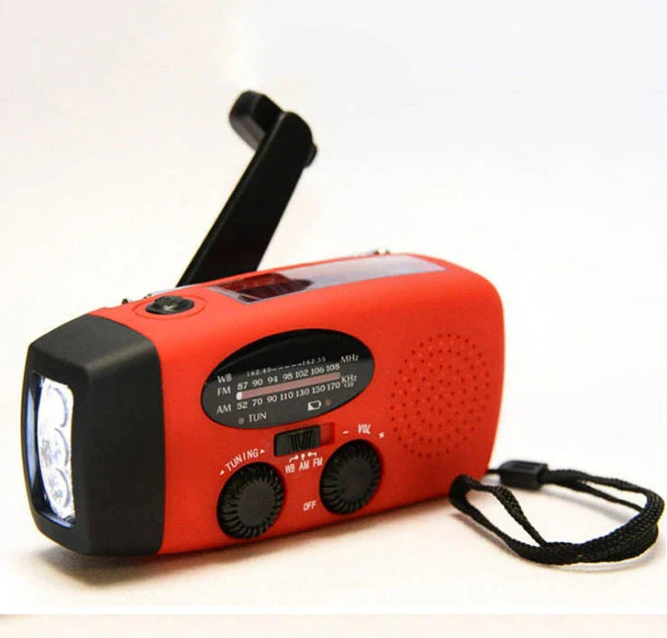 Portable solar and hand-cranked USB charging radio flashlight with LED illumination for outdoor adventures and emergency preparedness