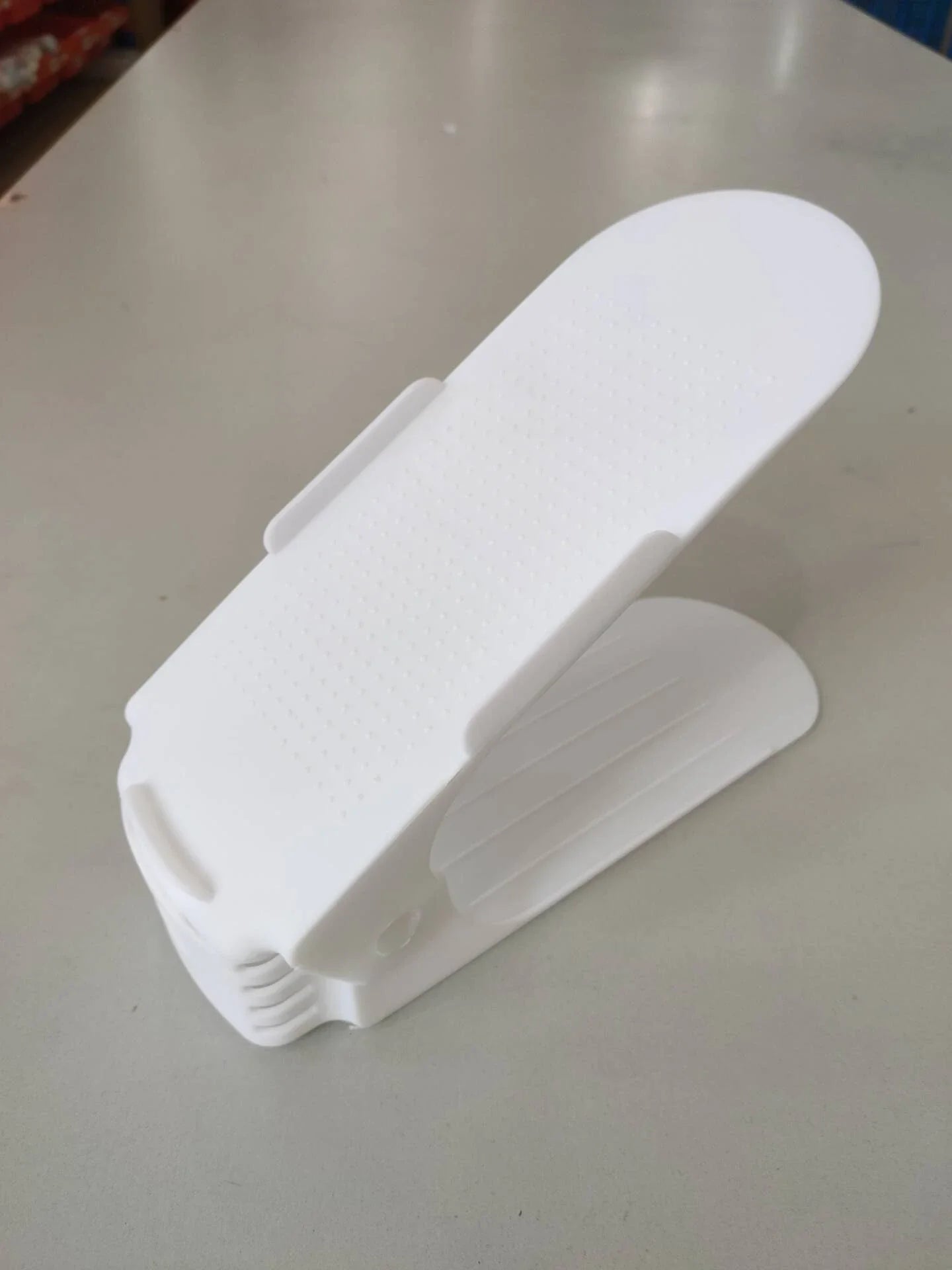 Adjustable dual-tier shoe organizer rack made of durable polypropylene material