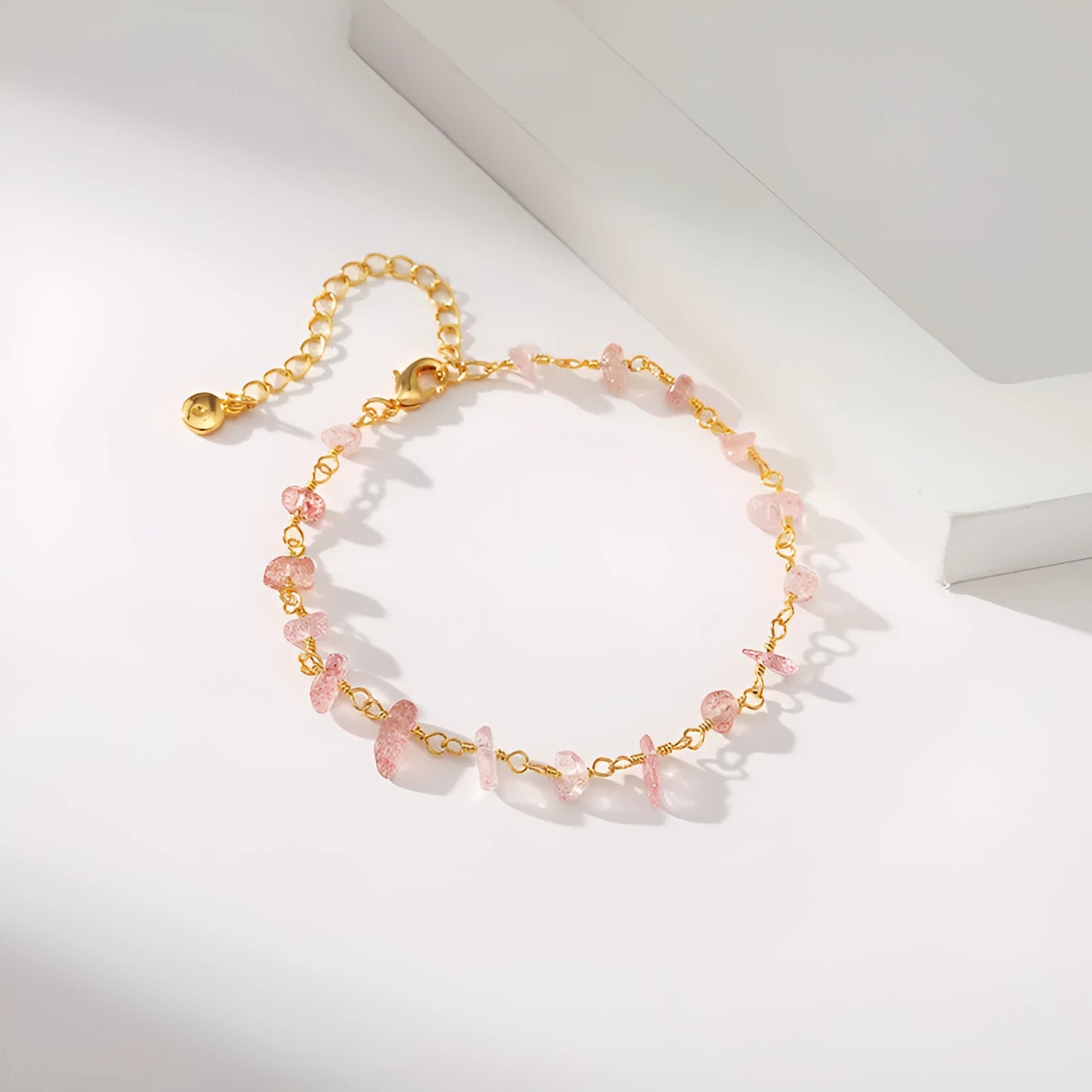 Geometric women's bracelet with irregular turquoise stones in 18K copper on a white background.