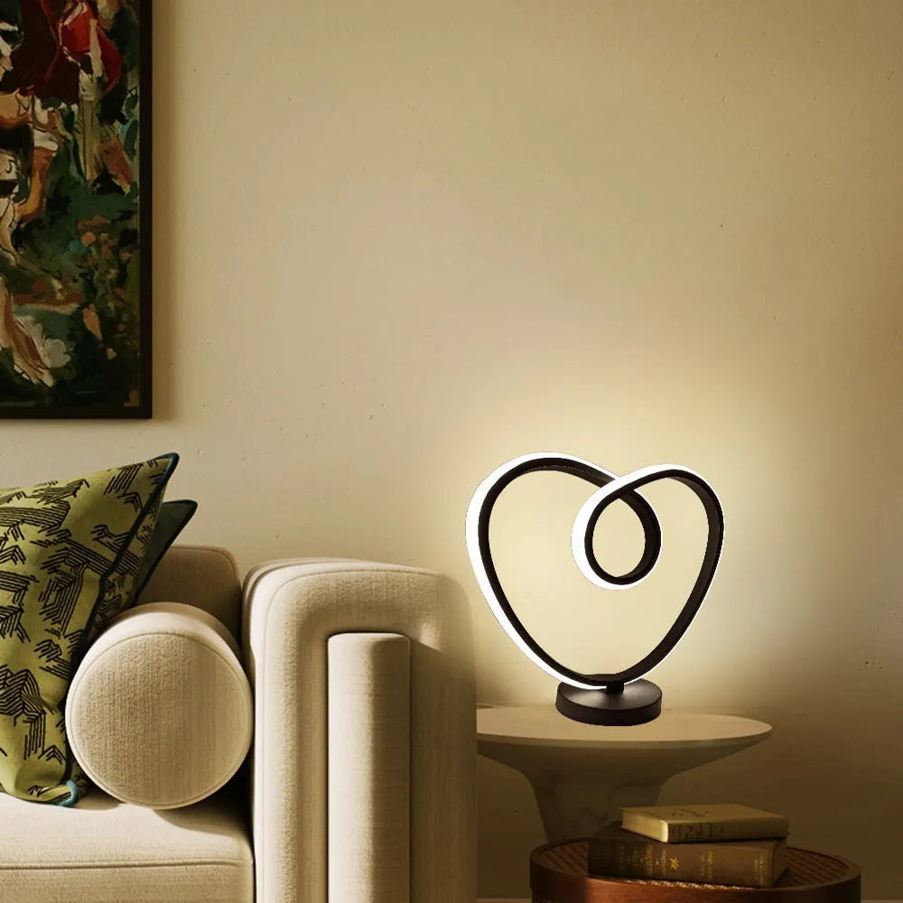 Black remote-controlled LED night light with Bluetooth remote on a bedside table.