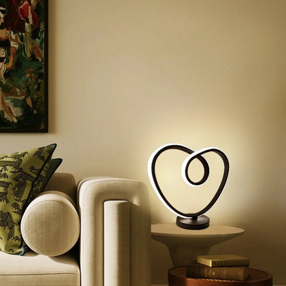 Black remote-controlled LED night light with Bluetooth remote on a bedside table.