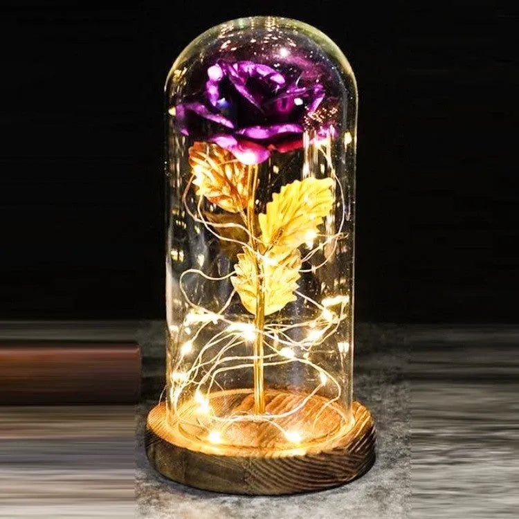 LED simulation rose ornament with glass lampshade on a solid wood base, showing a choice of rose colours.