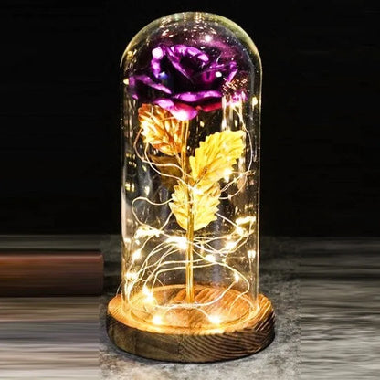 LED simulation rose ornament with glass lampshade on a solid wood base, showing a choice of rose colours.