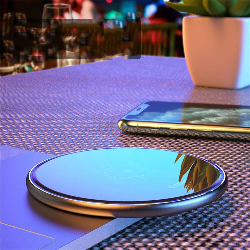 Black wireless charging pad with LED indicator light, measuring 10.1 by 7 centimetres
