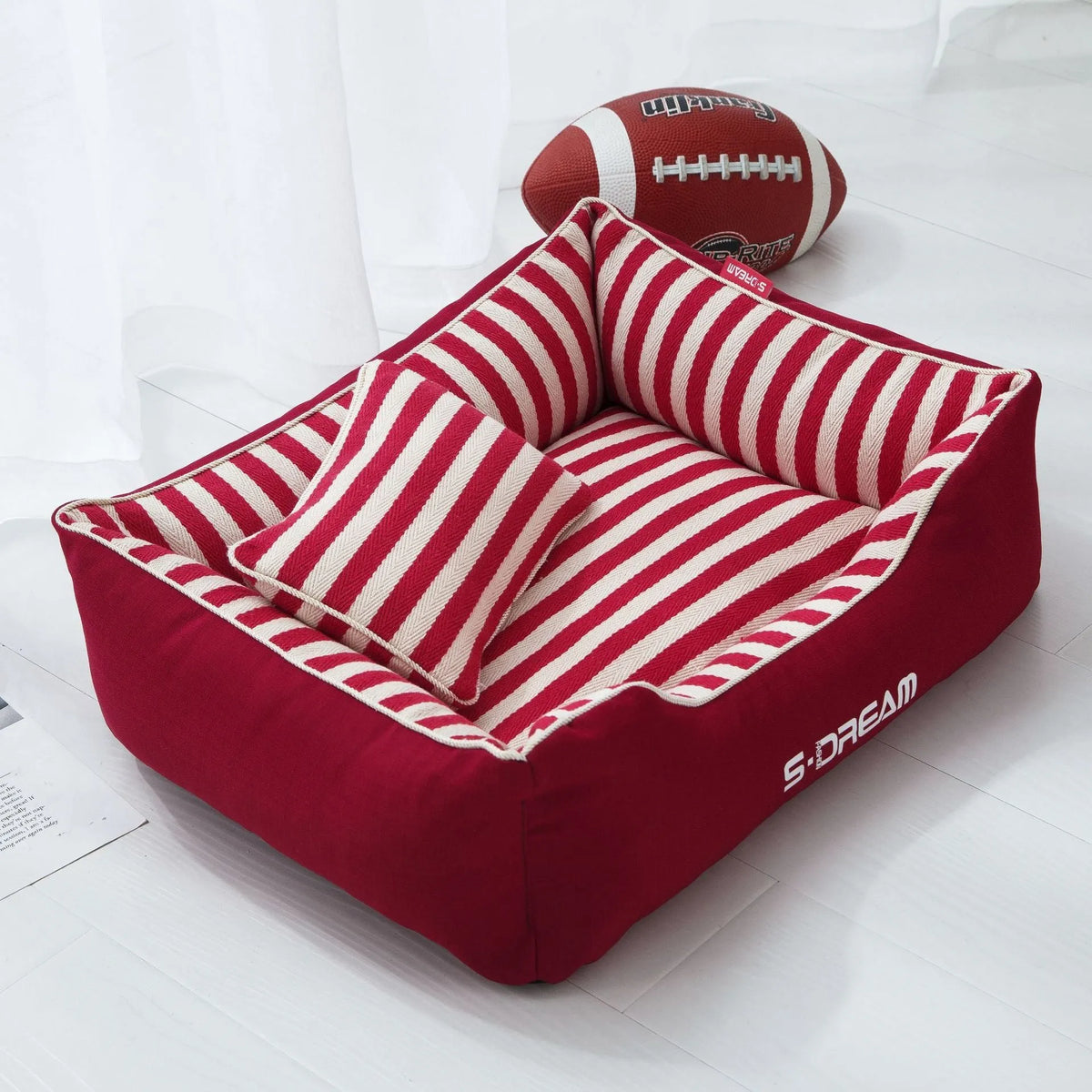 Removable washable dog kennel mat with fabric pillow in navy stripes and blue or red colour options.