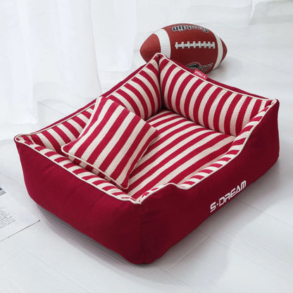 Removable washable dog kennel mat with fabric pillow in navy stripes and blue or red colour options.