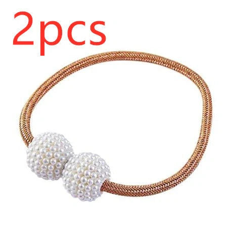 Magnetic curtain tiebacks with white pearl beads and fabric loops holding gathered curtain