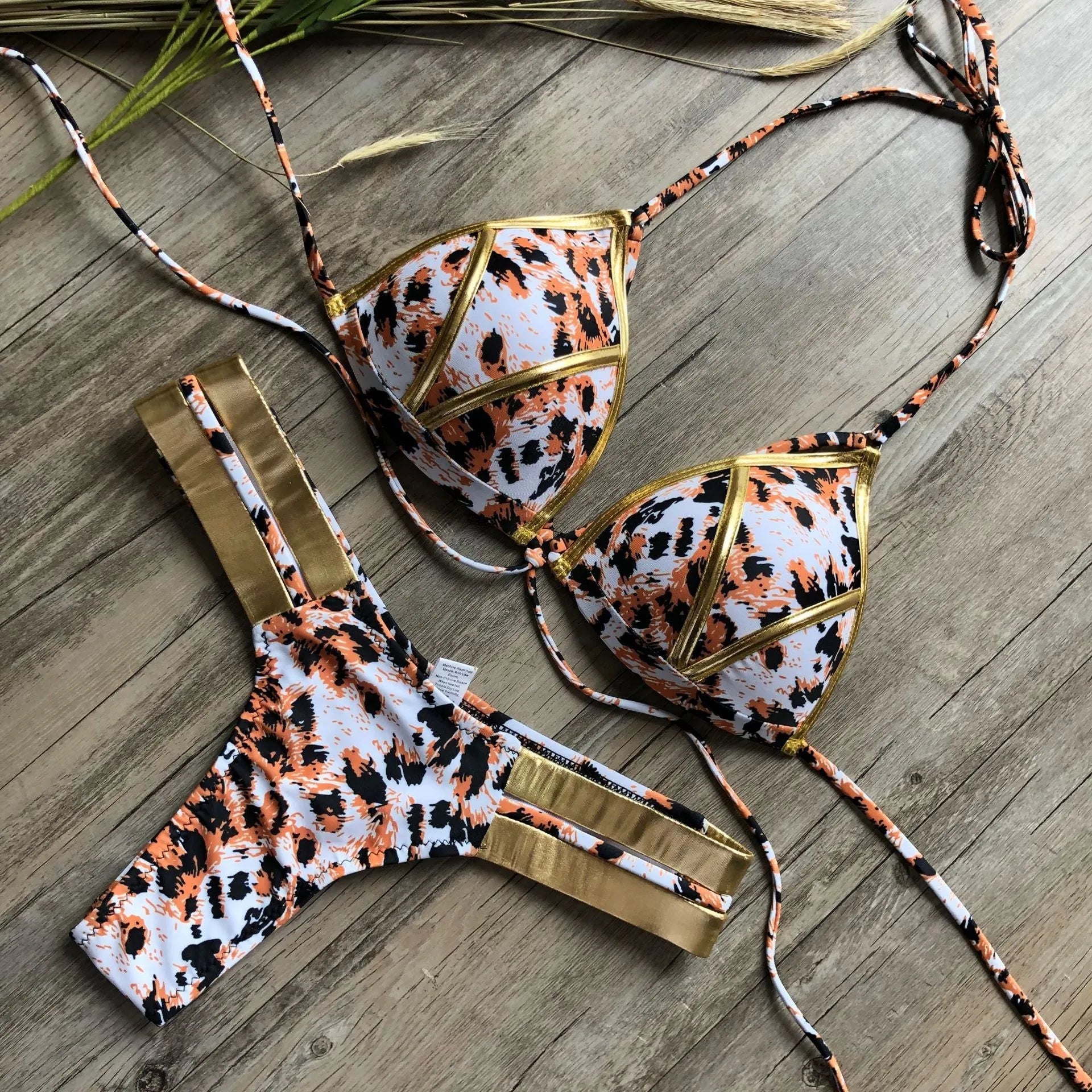 Women's bronzing bikini with padded cups in a selection of colours including black, blue, leopard print, and snakeskin print.