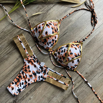 Women's bronzing bikini with padded cups in a selection of colours including black, blue, leopard print, and snakeskin print.