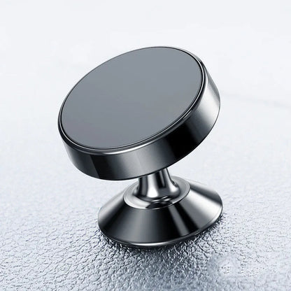 Silver aluminium alloy magnetic car phone holder with rotating ball head mounted on a car air vent.