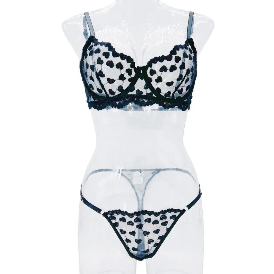 Women's black polyester two-piece suit with mesh panels and matching leggings, laid flat.