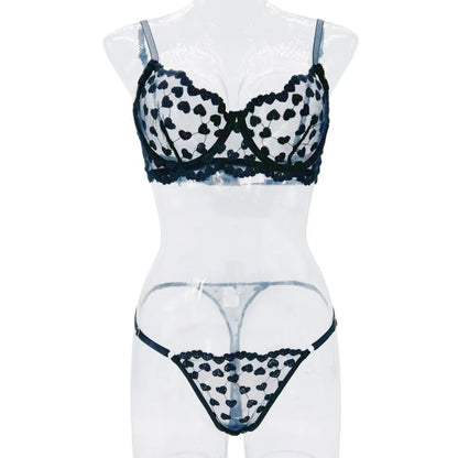 Women's black polyester two-piece suit with mesh panels and matching leggings, laid flat.