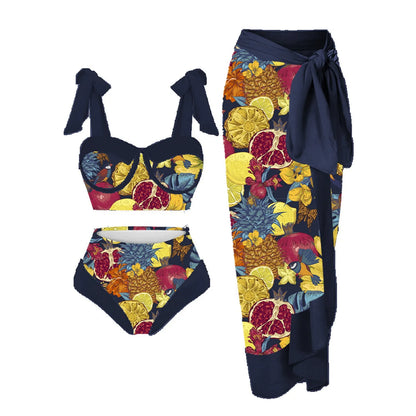 Women's pink and floral print split swimsuit three-piece set with skirt, bra, and panties.