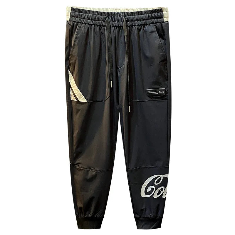 Black men's cropped casual trousers with ankle band made from thin ice silk cotton fabric.