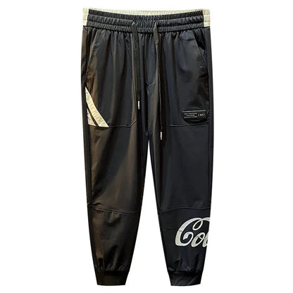 Black men's cropped casual trousers with ankle band made from thin ice silk cotton fabric.