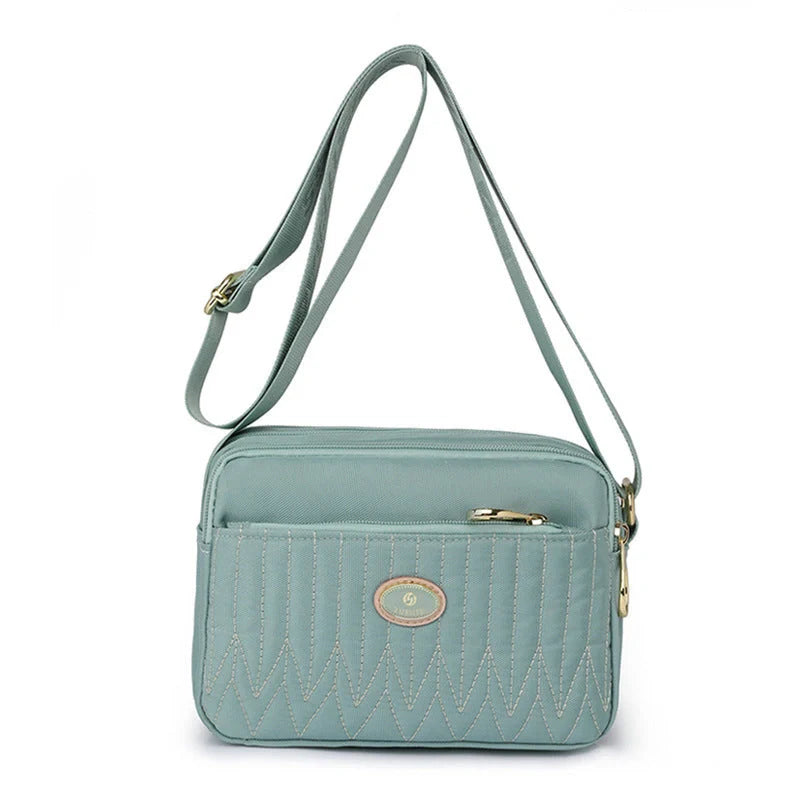 Compact nylon messenger bag for women in various colours with adjustable strap