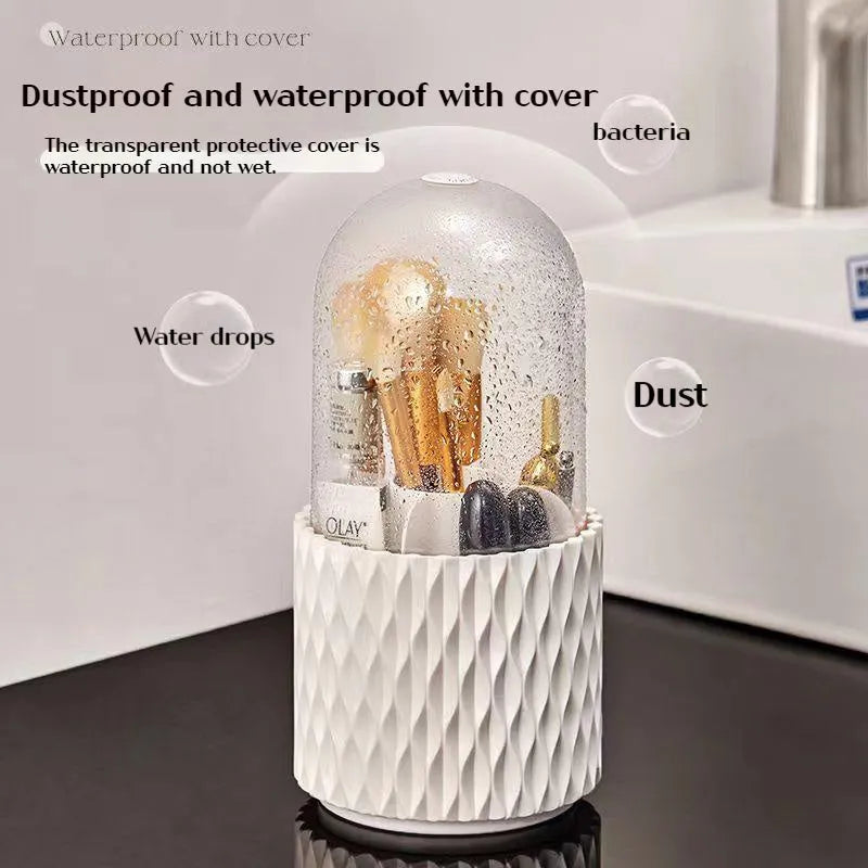 White rotating acrylic makeup brush holder with transparent dustproof lid on a desktop.
