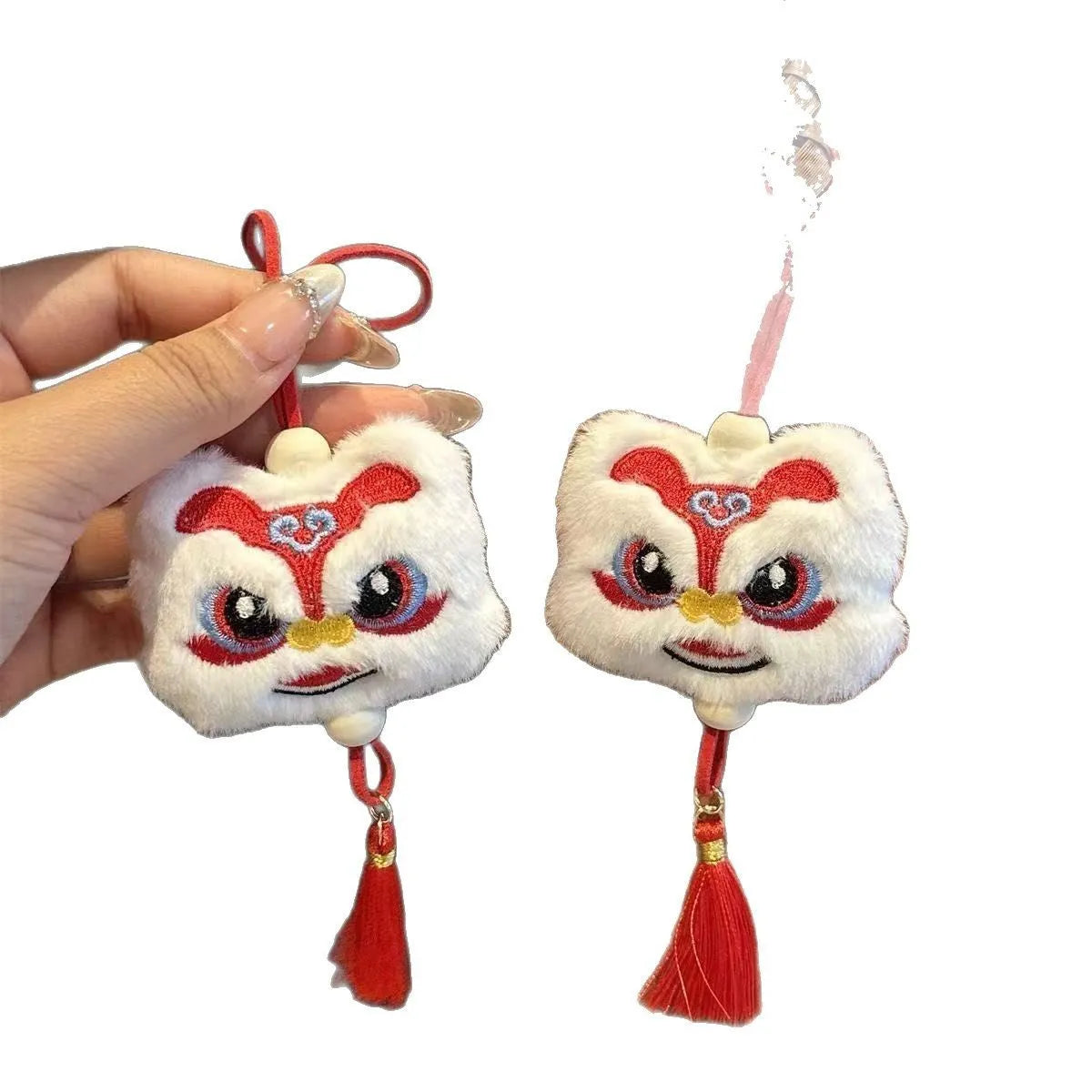 Handmade blue plush lion keychain with tassels and star stone decoration.