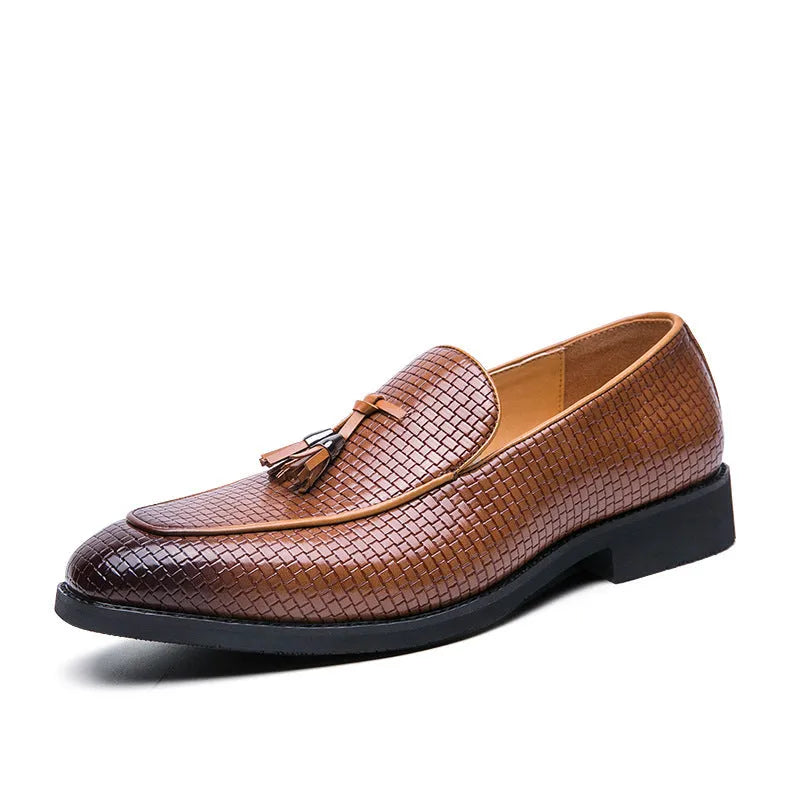 Men's black pointed toe slip on shoes with a tassel detail on the upper.