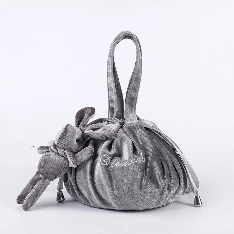 Adorable rabbit ear velvet cosmetic bags in various colors for storing and organizing makeup, toiletries, and other beauty essentials.