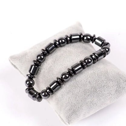 Black pentagram stone magnetic therapy bracelet with magnetite and hematite beads on a stretch band.