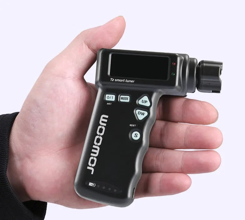 Black and white smart guitar tuner with LCD display and built-in string winder, 11cm width