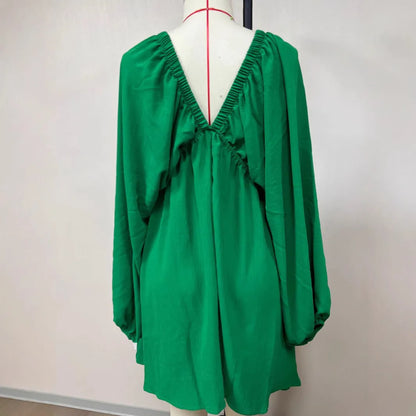 Women's apricot V-neck dress with long puff sleeves and a flounced swing skirt.
