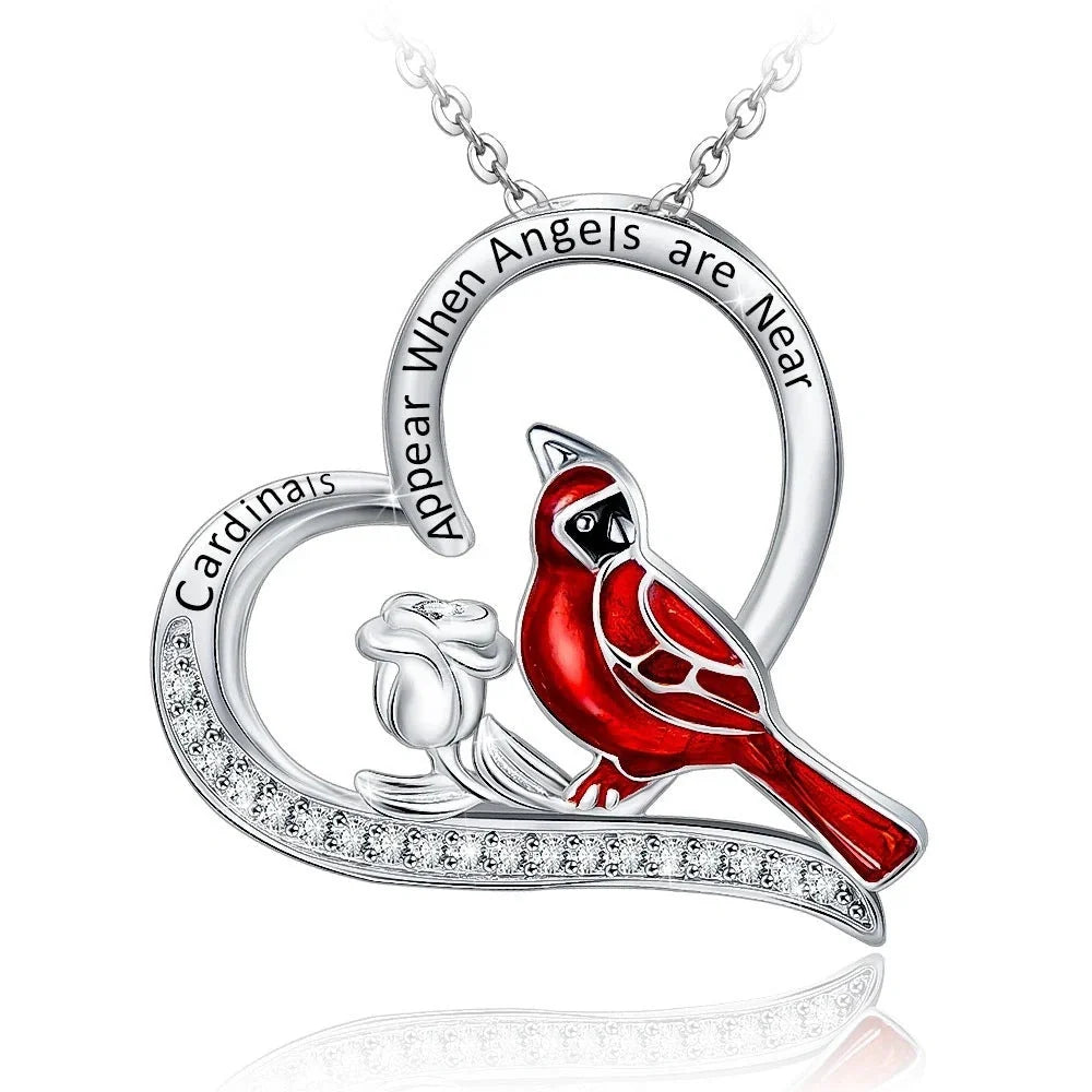 Elegant heart-shaped cardinal pendant necklace with a silver finish, perfect for gifting.
