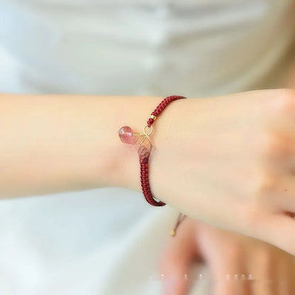 Women's adjustable bracelet with natural strawberry quartz cherry-shaped crystal charms on a chain.