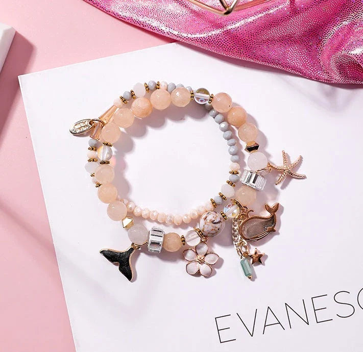 Whale tail bracelet with retro flower and starfish accents, a charming nautical accessory for UK fashionistas