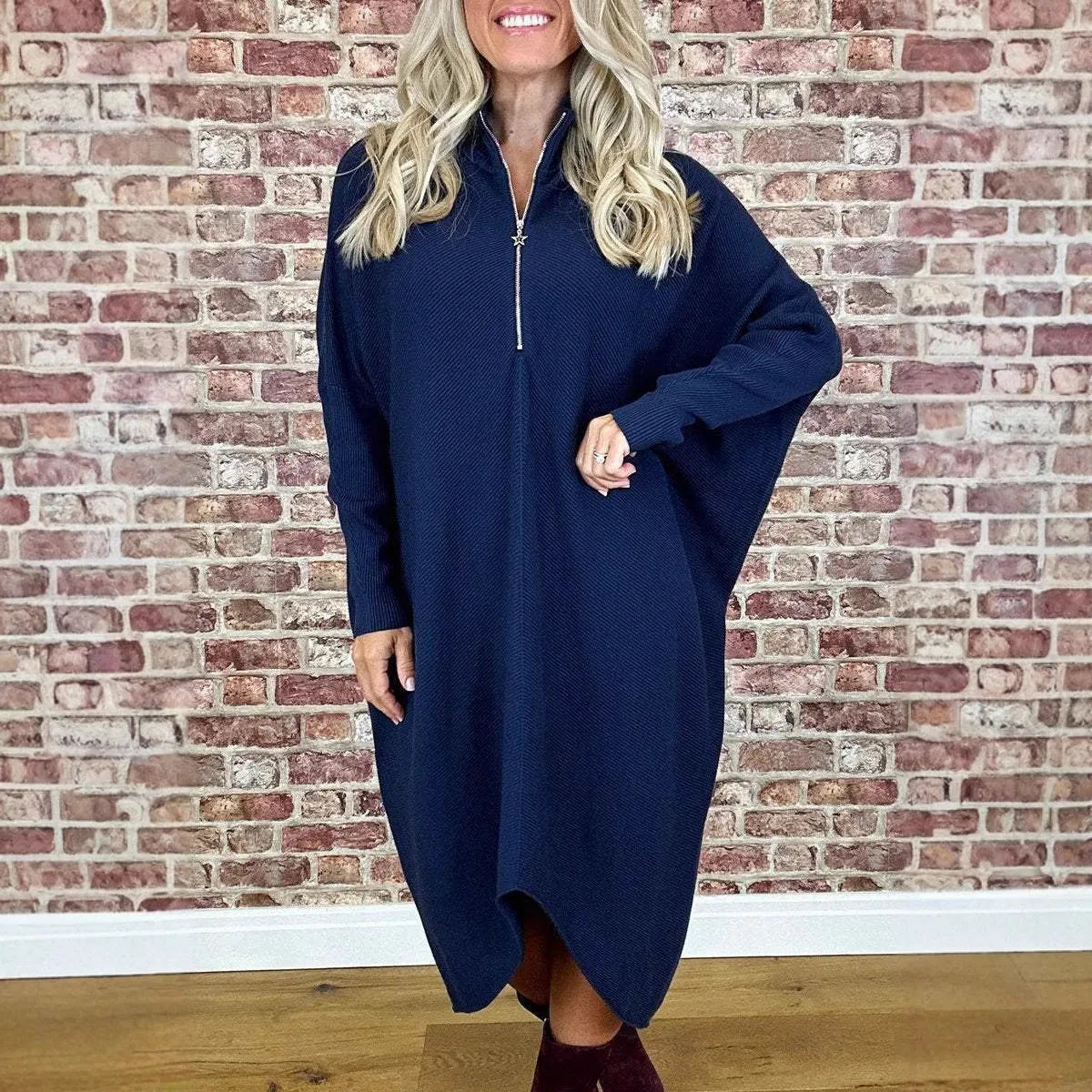 Women's solid colour loose knitted dress with a front zipper and raglan sleeves.