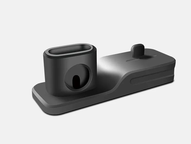 Black silicone 3-in-1 charging stand for Apple iPhone, Apple Watch, and AirPods on a desk