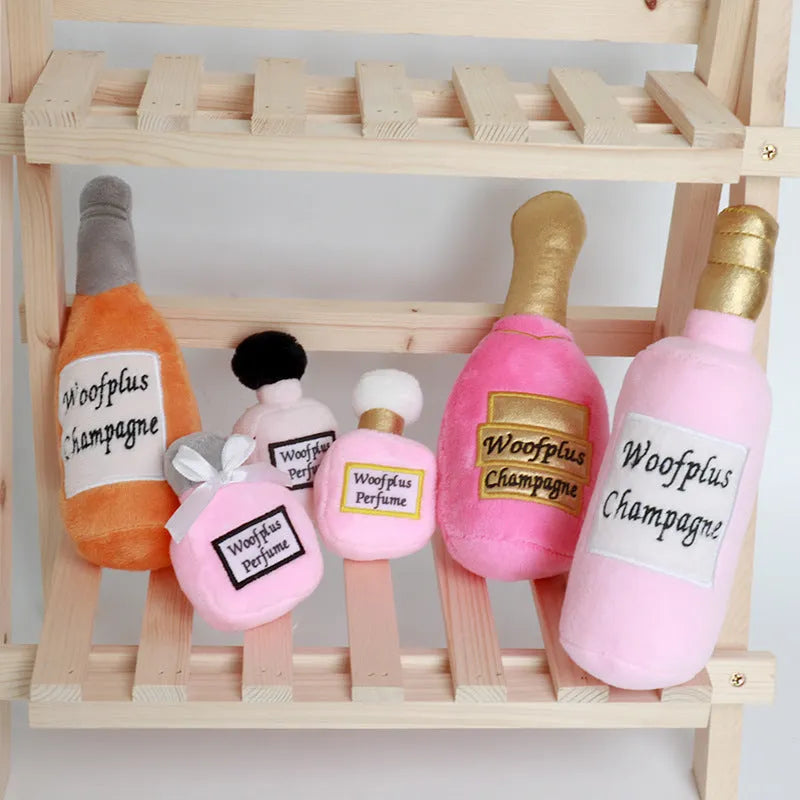 Soft green plush wine bottle pet toy for cats and dogs on a white background.