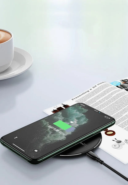 Black circular wireless charging disc for mobile phones with indicator light