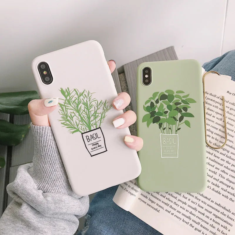 White silicone iPhone case with a painted green leaf plant design on the back.