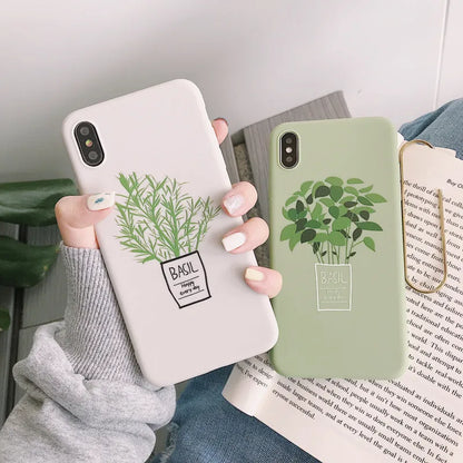 White silicone iPhone case with a painted green leaf plant design on the back.