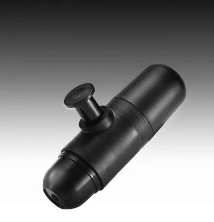 Black portable manual espresso maker with stainless steel parts, shown next to a coffee bag and mug.