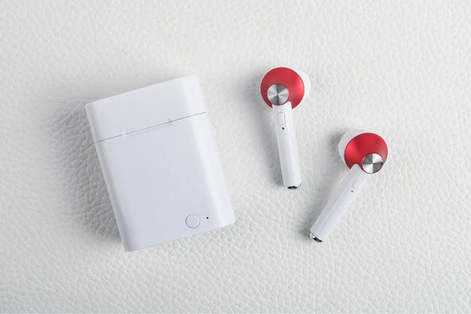 Black wireless sports Bluetooth earbuds showing battery display and placed next to a smartphone.