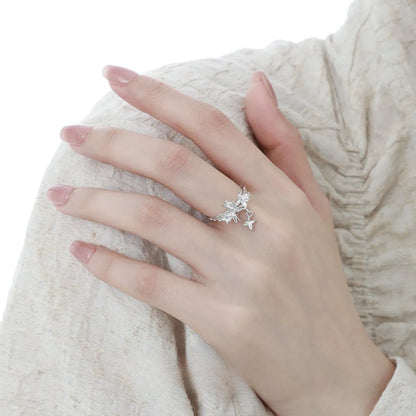 Adjustable open silver ring with a wild butterfly design in a choice of metallic finishes.